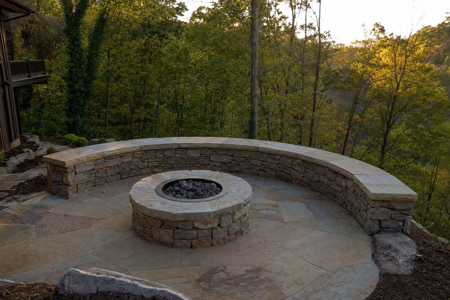 Natural stone fire pit with curved seating wall